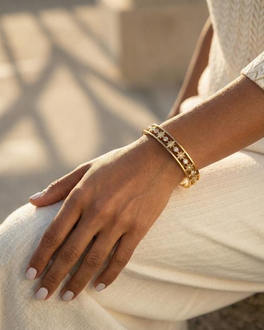 Maestra Celestial Starburst 18k gold-plated bangle, radiant star motif waterproof jewelry for daily glow.