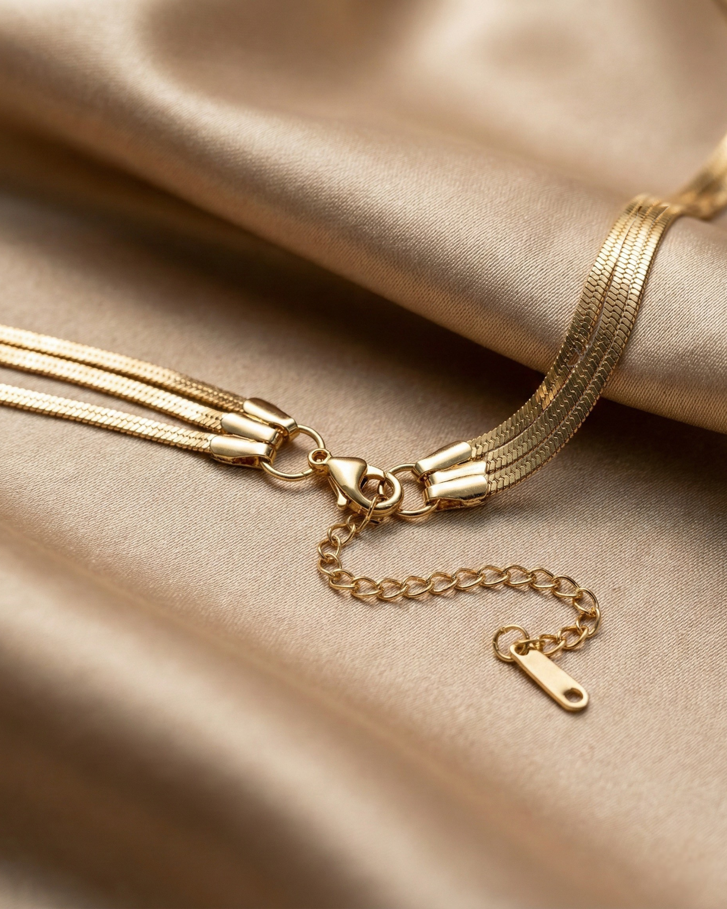 Gold bracelet on a beige fabric background
