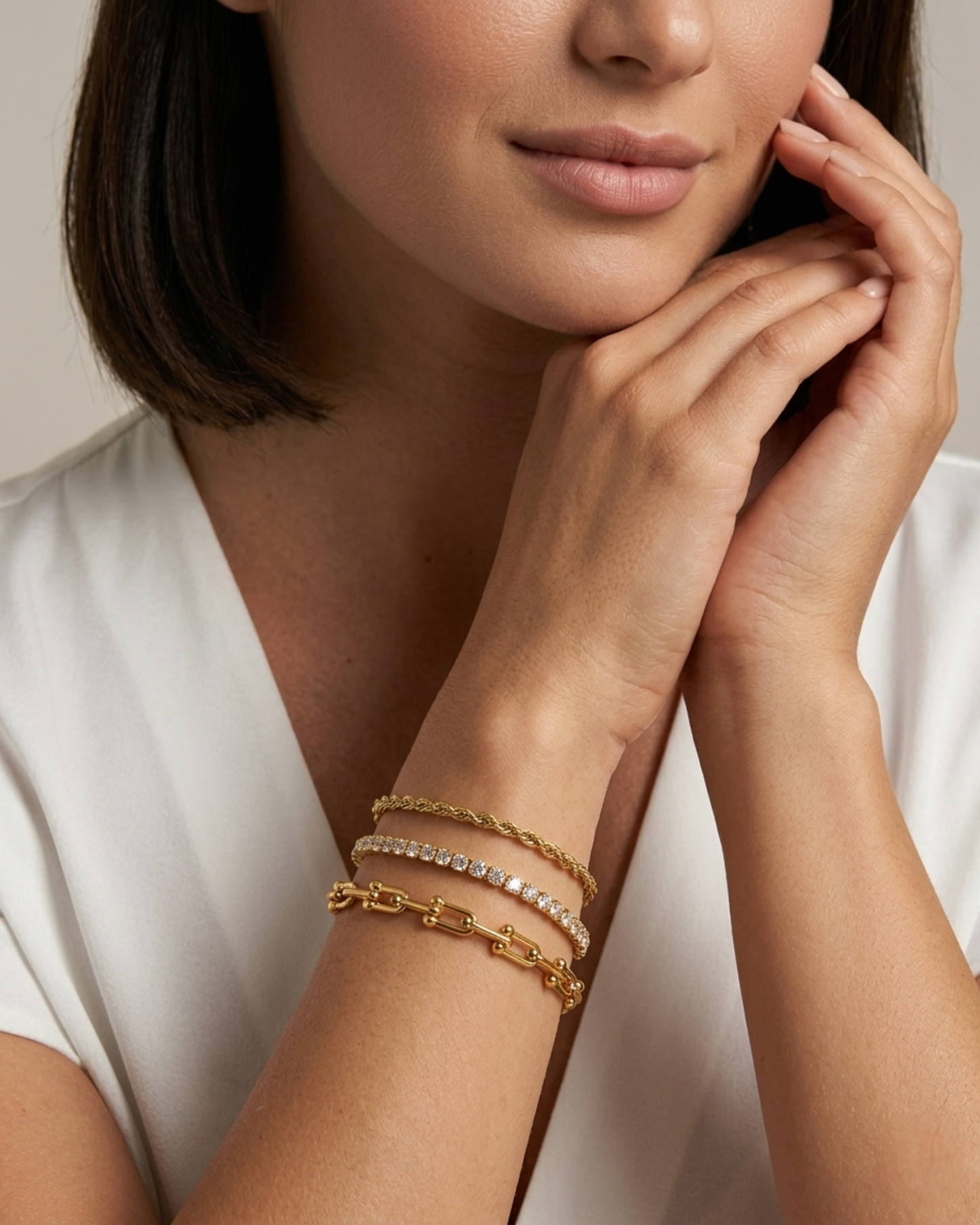 Maestra Nexus Interlock 18k gold-plated tennis bracelet stack, layered waterproof luxury chic jewelry.