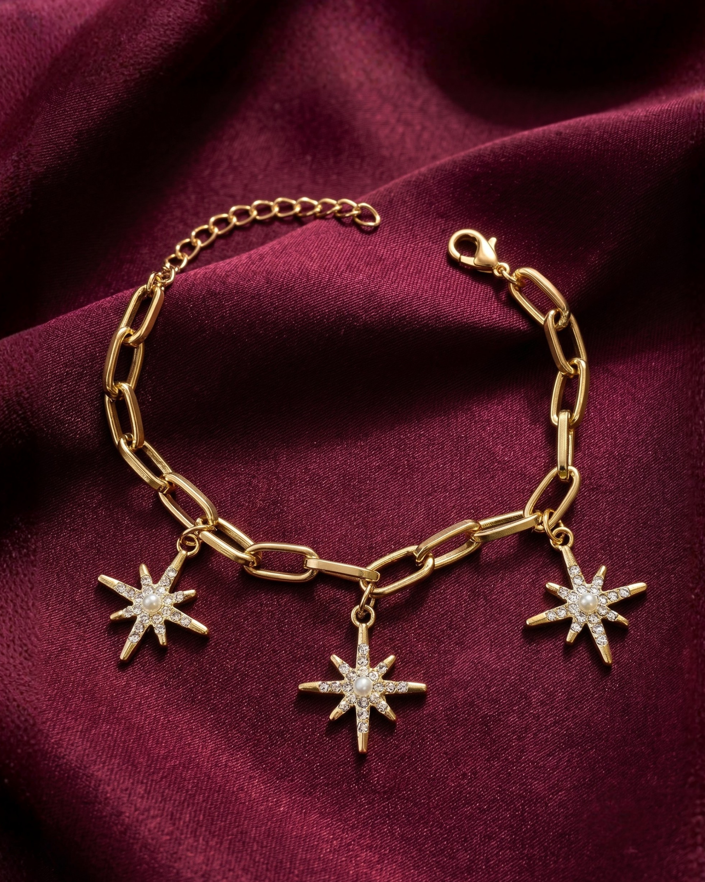 Gold plated star charm bracelet for women. Paperclip link celestial jewelry India. Lightweight office wear jewelry for working women. Crystal starburst charm bracelet alloy. Diwali and Rakhi jewelry gifts for wives. Gold tone festive wrist accessories for girls and friends.