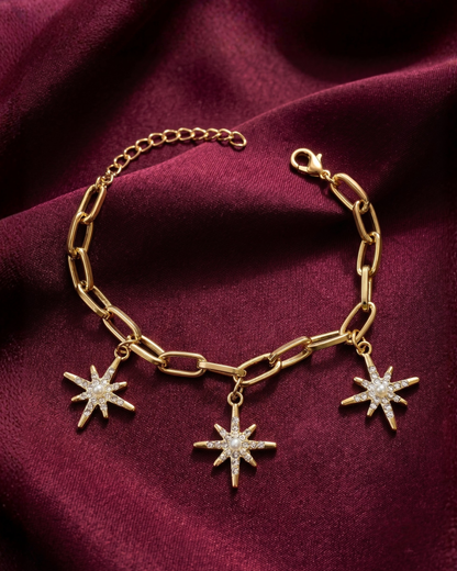 Gold plated star charm bracelet for women. Paperclip link celestial jewelry India. Lightweight office wear jewelry for working women. Crystal starburst charm bracelet alloy. Diwali and Rakhi jewelry gifts for wives. Gold tone festive wrist accessories for girls and friends.