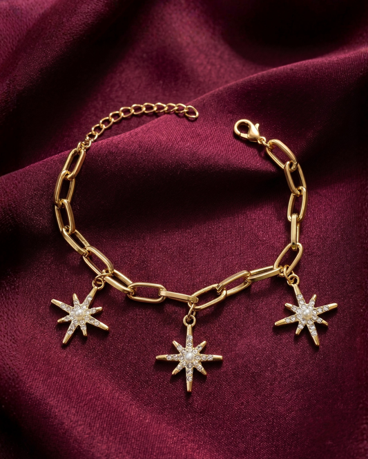 Gold plated star charm bracelet for women. Paperclip link celestial jewelry India. Lightweight office wear jewelry for working women. Crystal starburst charm bracelet alloy. Diwali and Rakhi jewelry gifts for wives. Gold tone festive wrist accessories for girls and friends.