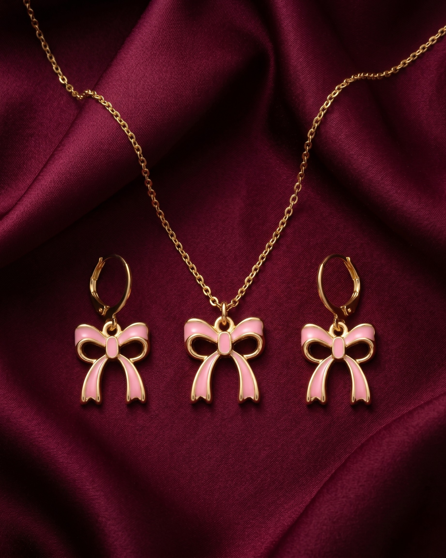 Gold plated white bow necklace and earrings set for women. 3 piece matching ribbon charm jewelry combo India. Lightweight office wear necklace and earring sets for working women. White enamel bow pendant and drop earrings alloy. Diwali, Navratri, and Rakhi jewelry gifts for wives. Gold tone festive neck and ear accessories for girls, women, and friends