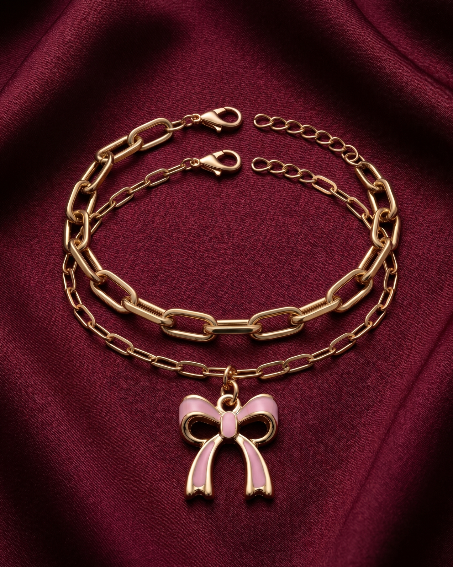 Gold plated white bow charm bracelet stack for women. 2 piece layered paperclip link bracelets India. Lightweight office wear jewelry for working women. White enamel ribbon charm bracelet set alloy. Diwali and Rakhi jewelry gifts for wives. Gold tone festive wrist accessories for girls, women, and friends.