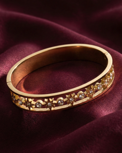 Maestra Celestial Starburst 18k gold-plated bangle, radiant star motif waterproof jewelry for daily glow.