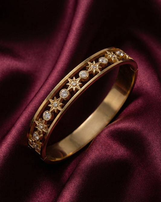 Maestra Celestial Starburst 18k gold-plated bangle, radiant star motif waterproof jewelry for daily glow.