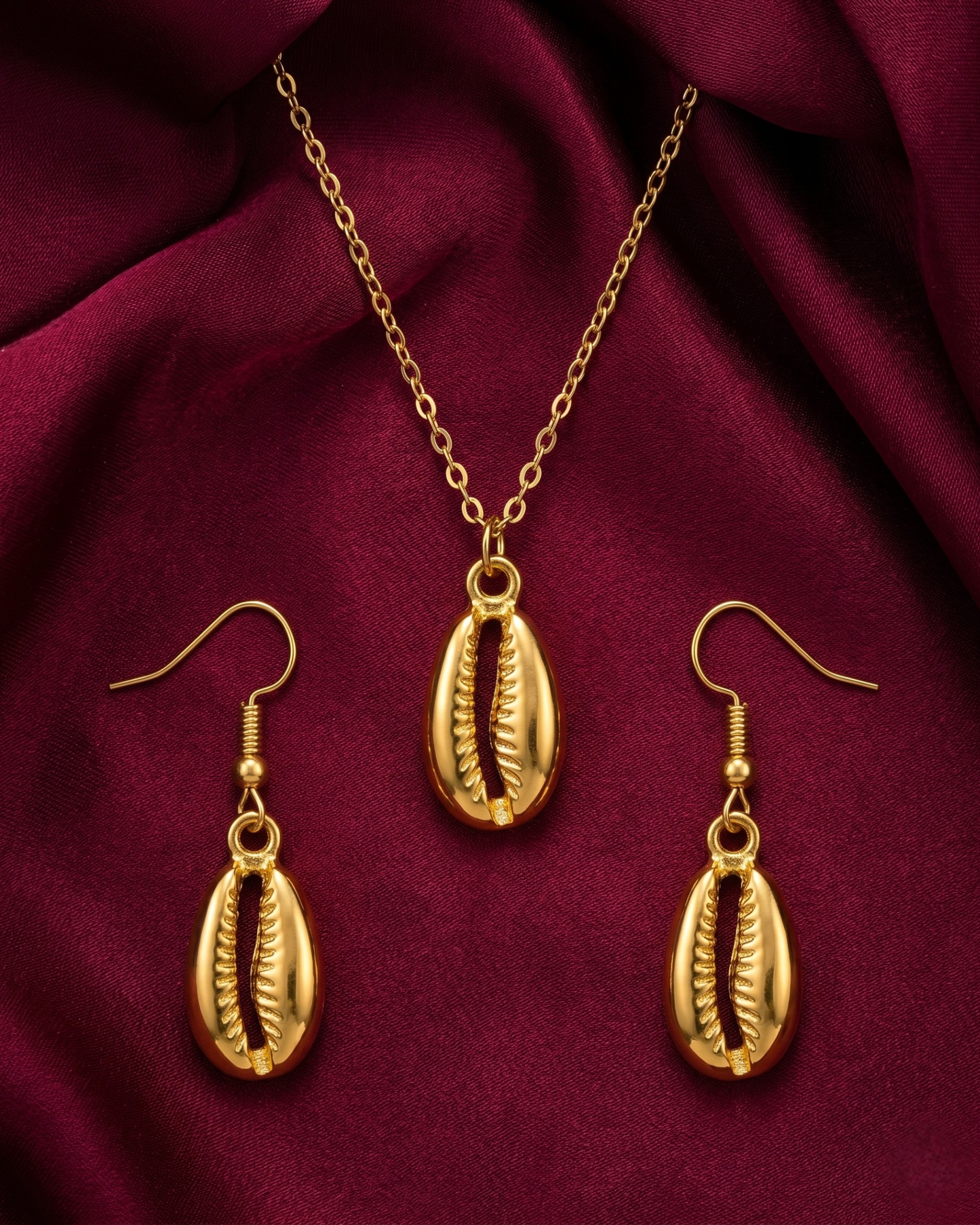 Gold plated cowrie necklace and earrings set for women. 3 piece matching ridged fan shell jewelry combo India. Lightweight office wear necklace and earring sets for working women. Textured sea shell pendant and fish hook drop earrings alloy. Diwali, Navratri, and Rakhi jewelry gifts for wives. Gold tone festive neck and ear accessories for girls, women, and friends