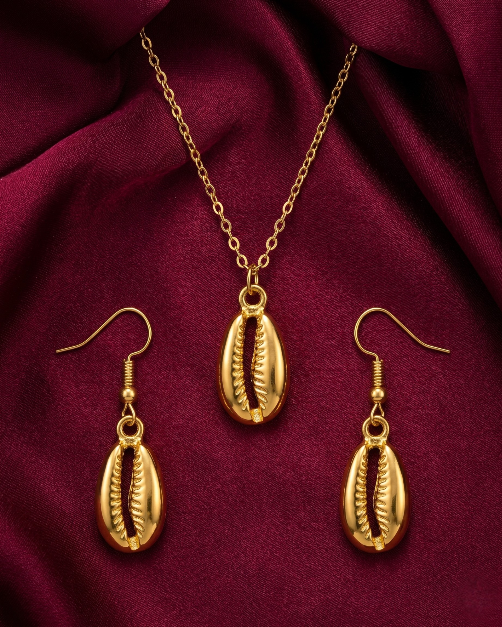 Gold plated cowrie necklace and earrings set for women. 3 piece matching ridged fan shell jewelry combo India. Lightweight office wear necklace and earring sets for working women. Textured sea shell pendant and fish hook drop earrings alloy. Diwali, Navratri, and Rakhi jewelry gifts for wives. Gold tone festive neck and ear accessories for girls, women, and friends