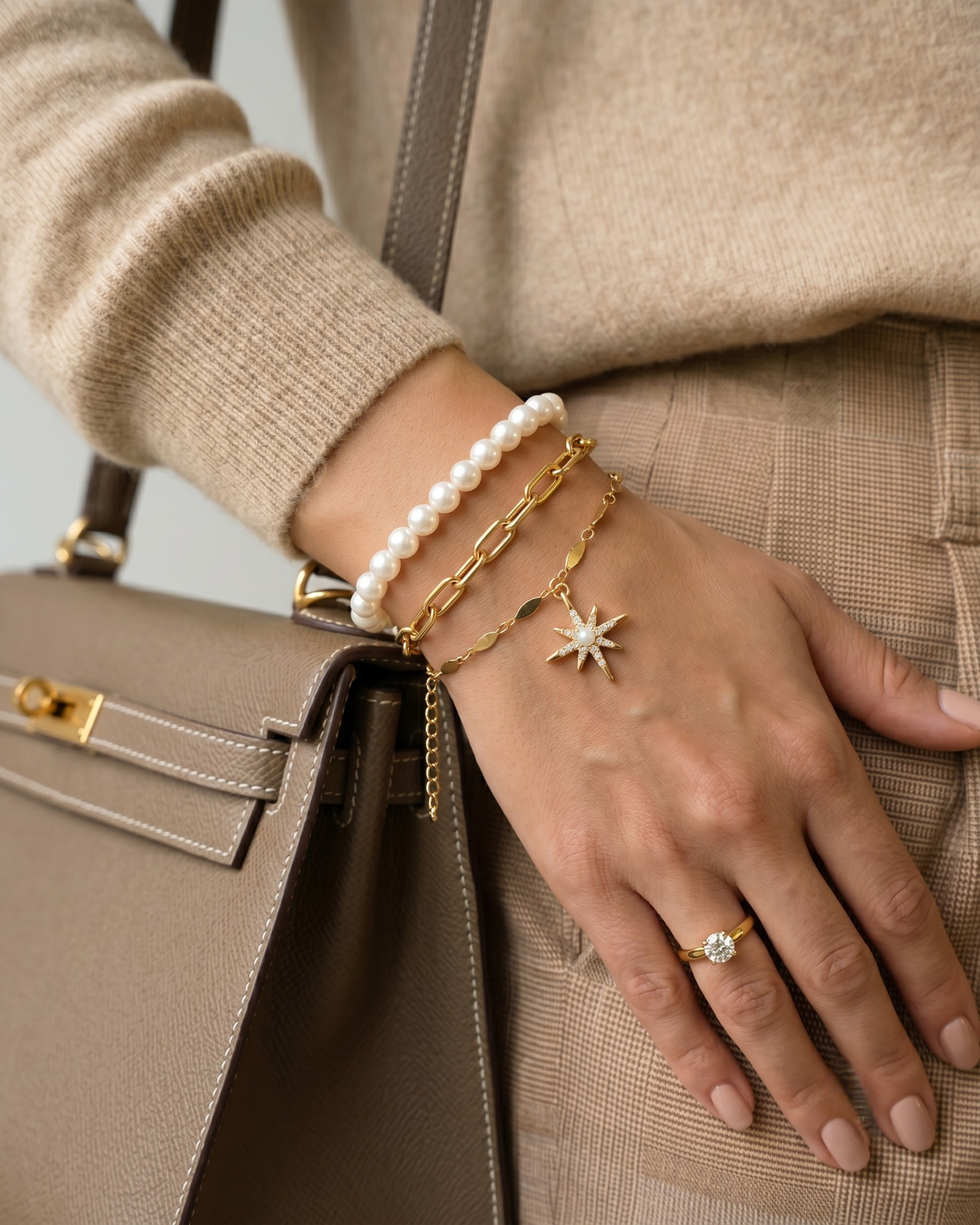 Gold plated pearl and paperclip bracelet stack for women. 3 piece layered link bracelets India. Lightweight office wear jewelry for working women. White pearl and crystal starburst charm bracelet set alloy. Diwali and Rakhi jewelry gifts for wives. Gold tone festive wrist accessories for girls and friends.