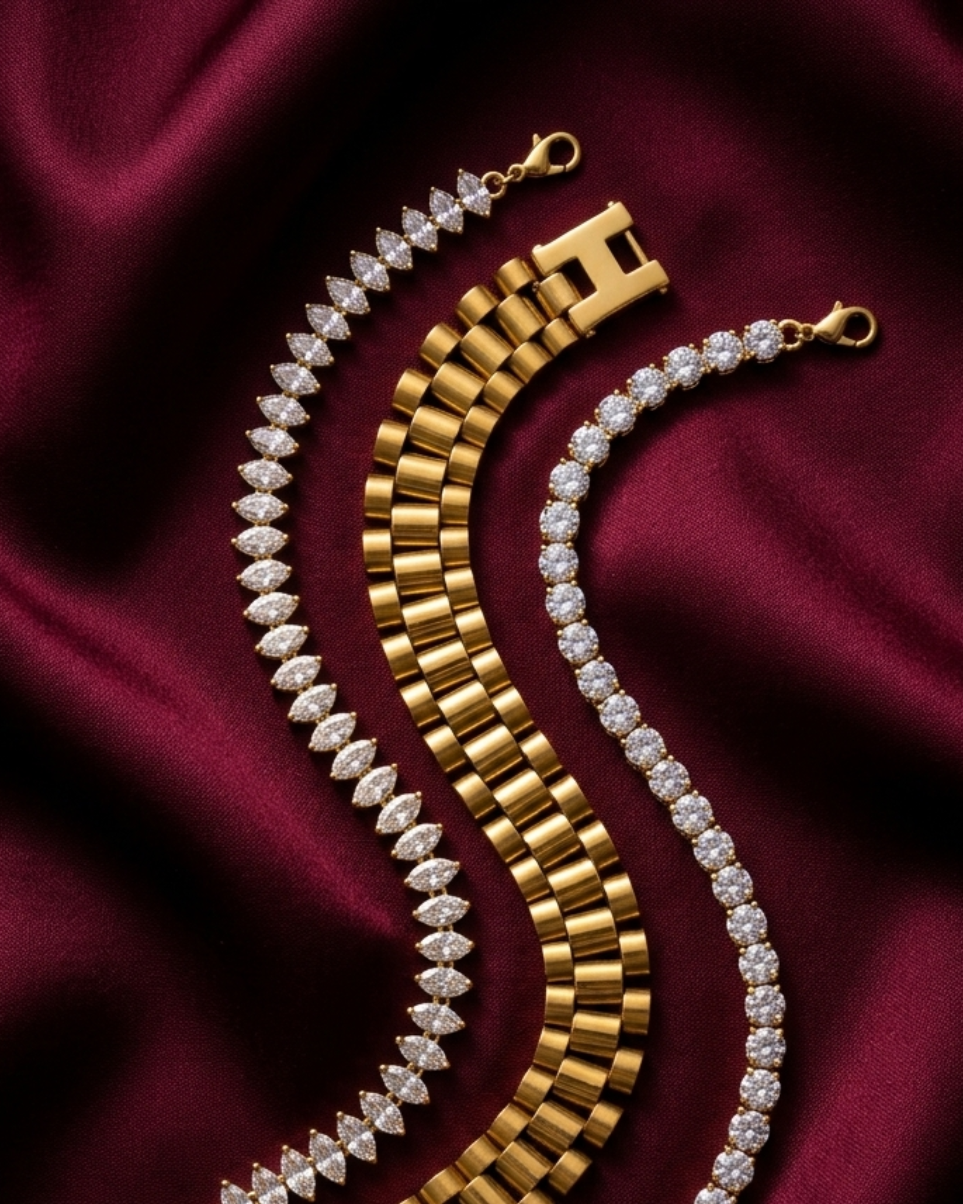 Premium anti-tarnish stainless steel watchlink, marquise, and American Diamond tennis bracelet stack on deep red fabric.