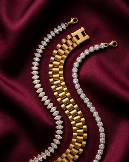 Premium anti-tarnish stainless steel watchlink, marquise, and American Diamond tennis bracelet stack on deep red fabric.