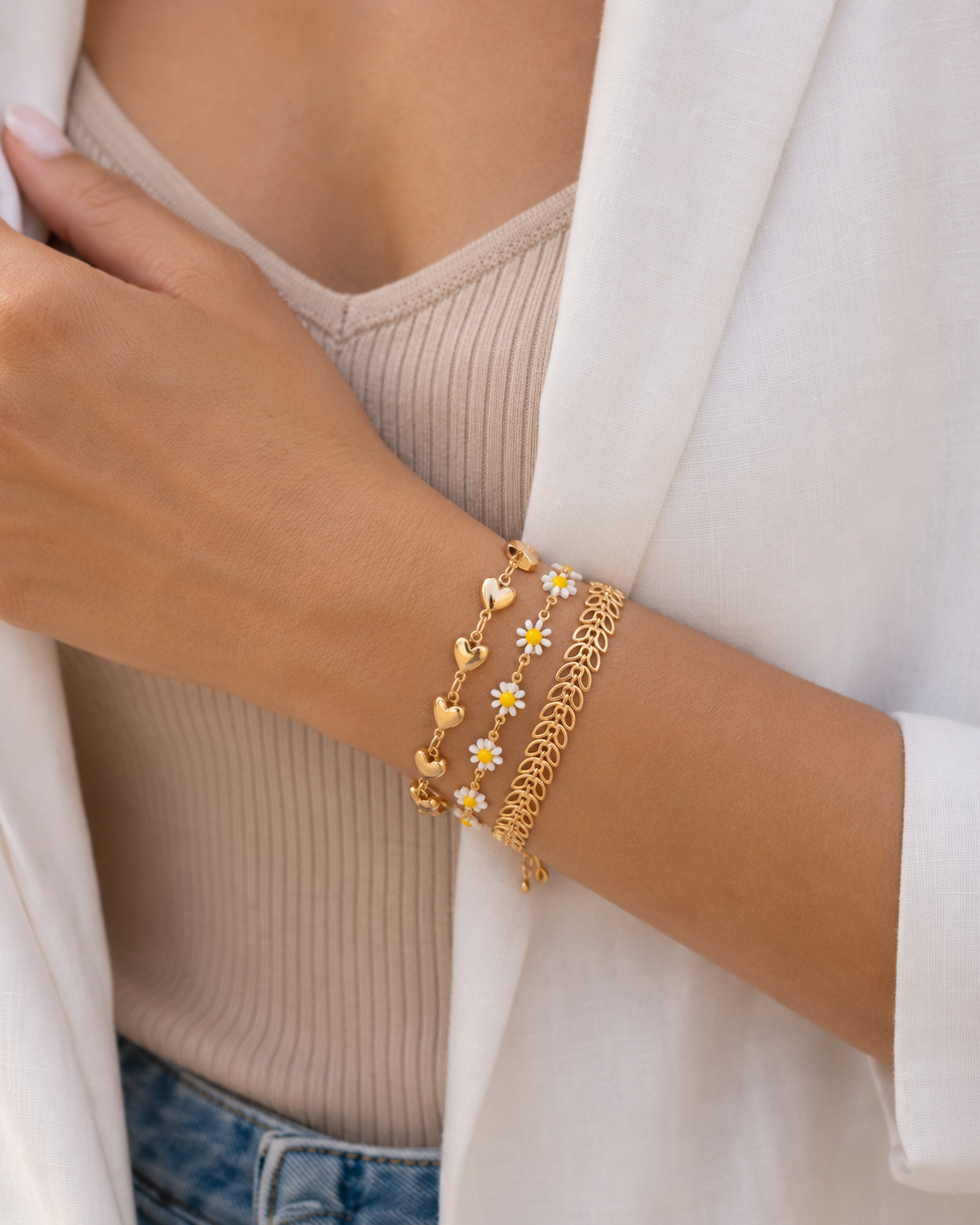 Gold plated heart and daisy bracelet stack for women. 3 piece layered link bracelets India. Lightweight office wear jewelry for working women. Enamel daisy and leaf charm bracelet set alloy. Diwali and Rakhi jewelry gifts for wives. Gold tone festive wrist accessories for girls and friends.