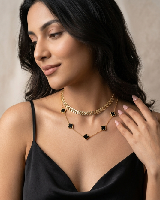 Maestra Hera black clover layered necklace stack, 18k gold-plated waterproof midnight clover and laurel leaf jewelry.