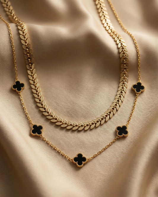 Maestra Hera black clover layered necklace stack, 18k gold-plated waterproof onyx clover and laurel leaf jewelry.