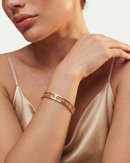 Maestra Mini Iris 18k gold-plated evil eye bangle, minimalist waterproof protection jewelry for stacking.
