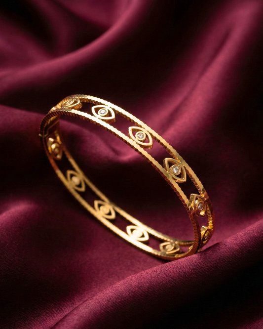 Maestra Mini Iris 18k gold-plated evil eye bangle, minimalist waterproof protection jewelry for stacking.