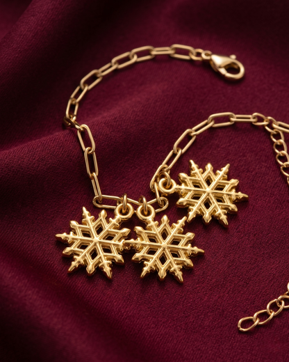 Gold plated snowflake charm bracelet for women. Paperclip chain link winter jewelry India. Lightweight office wear jewelry for working women. 3 snowflake charm hanging bracelet alloy. Diwali, Navratri, and Rakhi jewelry gifts for wives. Gold tone festive wrist accessories for girls, women, and friends.