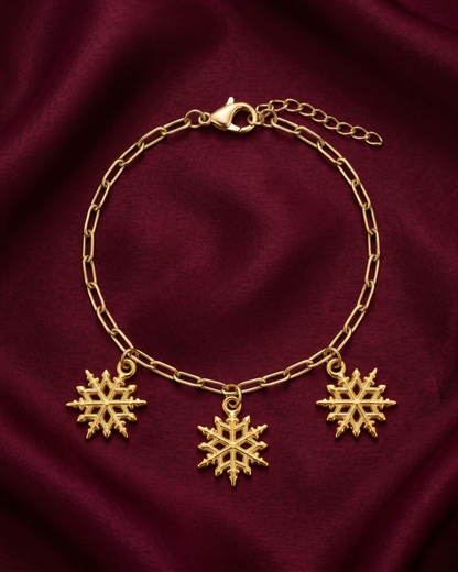Gold plated snowflake charm bracelet for women. Paperclip chain link winter jewelry India. Lightweight office wear jewelry for working women. 3 snowflake charm hanging bracelet alloy. Diwali, Navratri, and Rakhi jewelry gifts for wives. Gold tone festive wrist accessories for girls, women, and friends.