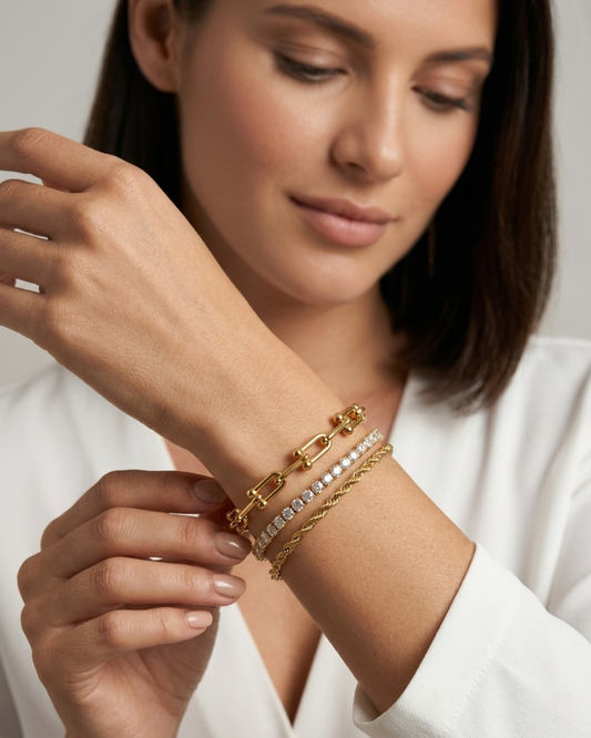 Maestra Nexus Interlock 18k gold-plated tennis bracelet stack, layered waterproof luxury chic jewelry.