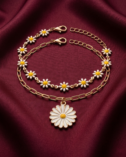 Gold plated daisy charm bracelet stack for women. 2 piece layered flower link bracelets India. Lightweight office wear jewelry for working women. Enamel daisy and paperclip chain bracelet set alloy. Diwali and Rakhi jewelry gifts for wives. Gold tone festive wrist accessories for girls and friends.