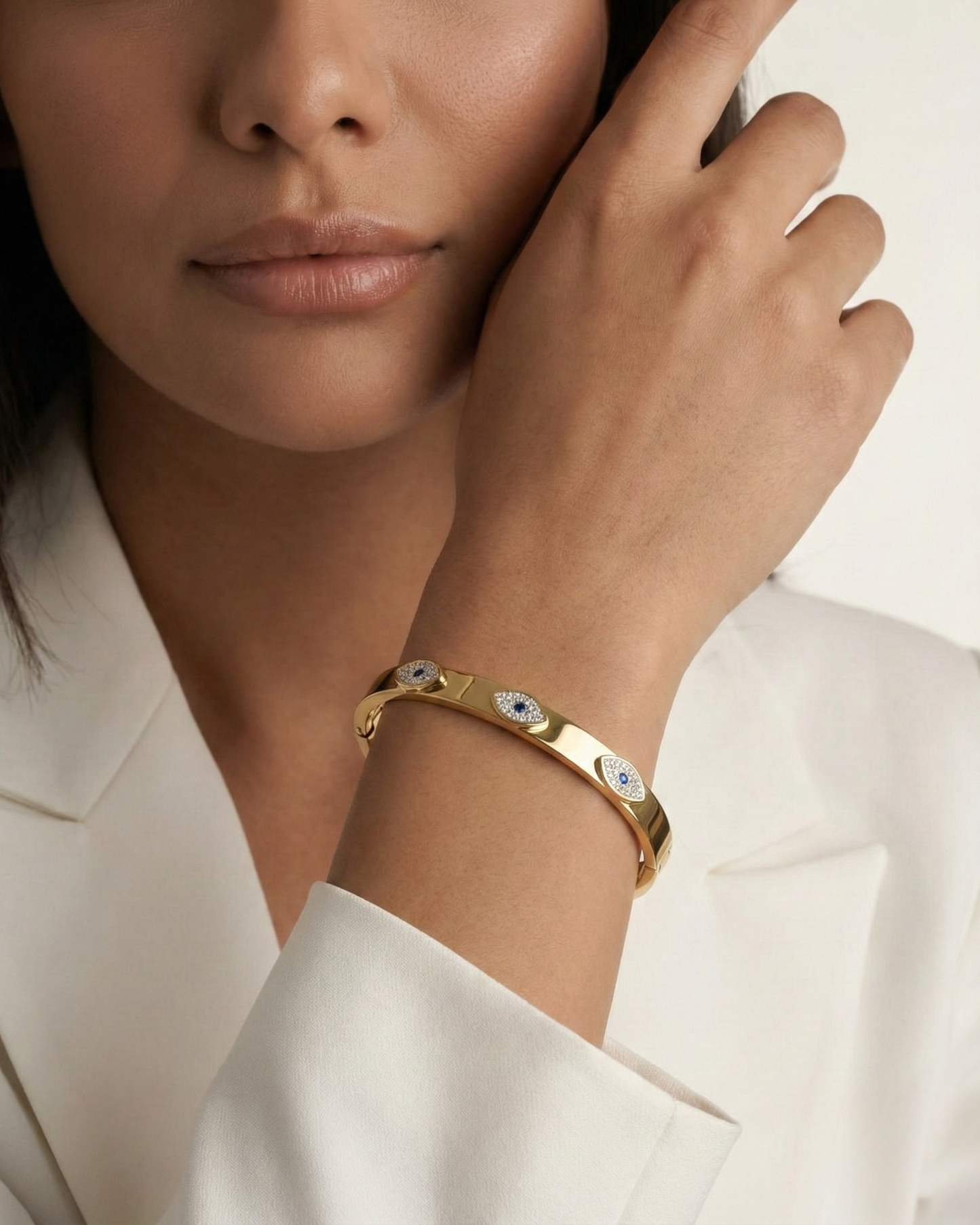Maestra Sapphire Gaze 18k gold-plated evil eye bangle with blue stones, waterproof and anti-tarnish jewelry.
