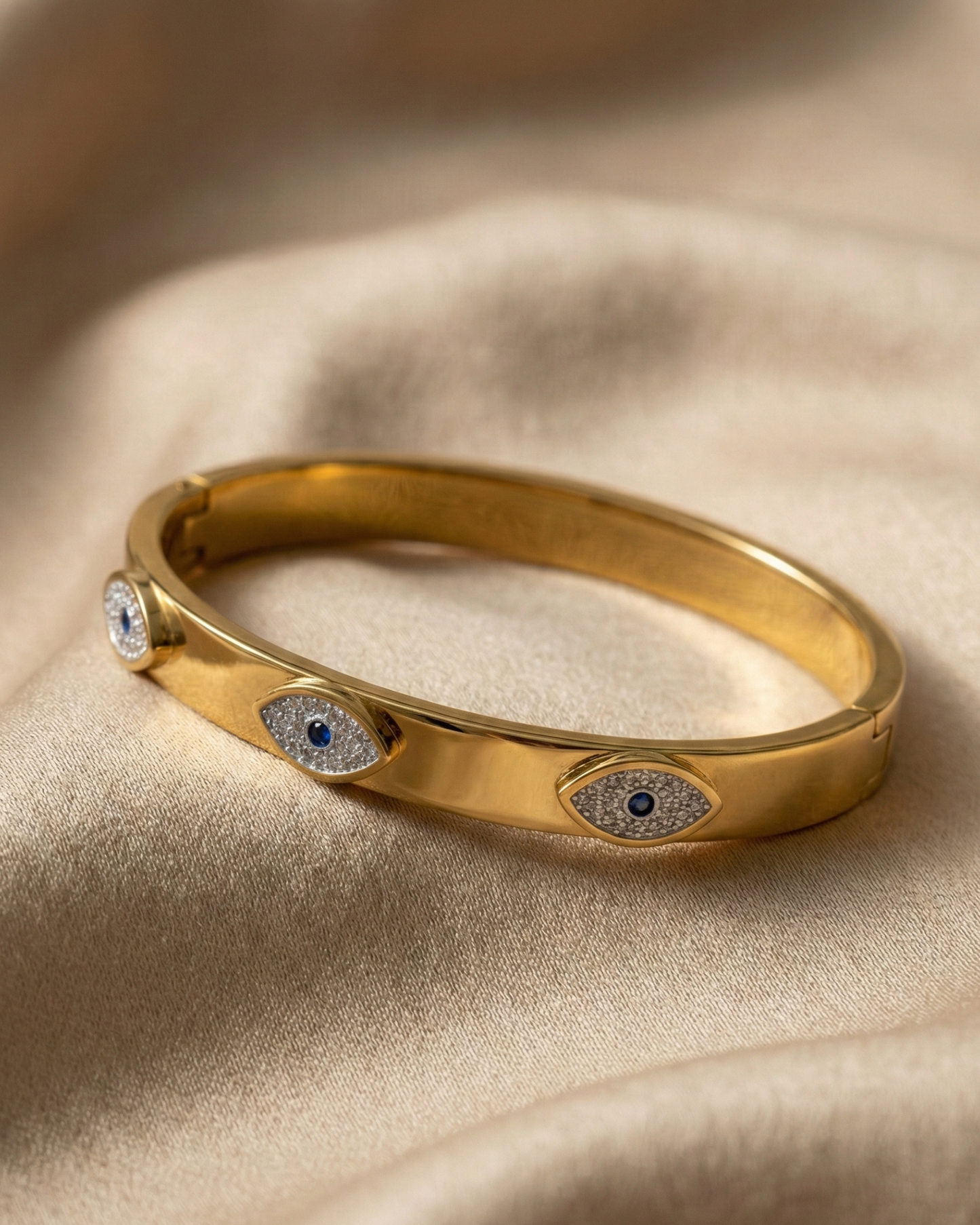 Maestra Sapphire Gaze 18k gold-plated evil eye bangle with blue stones, waterproof and anti-tarnish jewelry.