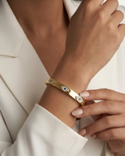 Maestra Sapphire Gaze 18k gold-plated evil eye bangle with blue stones, waterproof and anti-tarnish jewelry.