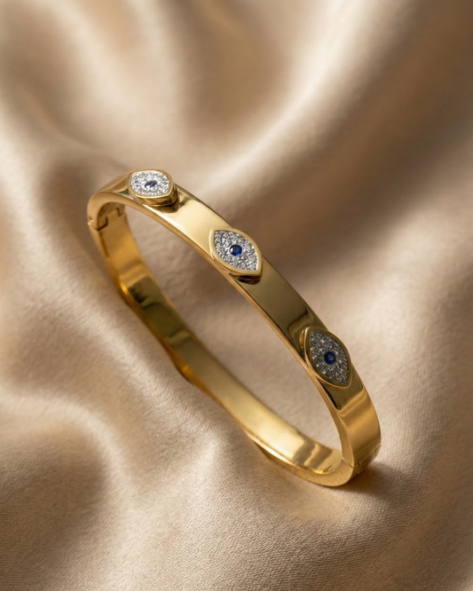 Maestra Sapphire Gaze 18k gold-plated evil eye bangle with blue stones, waterproof and anti-tarnish jewelry.