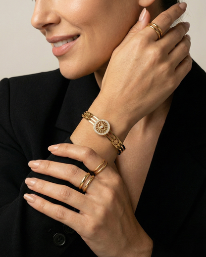 Maestra Sentinel 18k gold-plated evil eye and hamsa bangle, protective waterproof jewelry with symbolic charms.