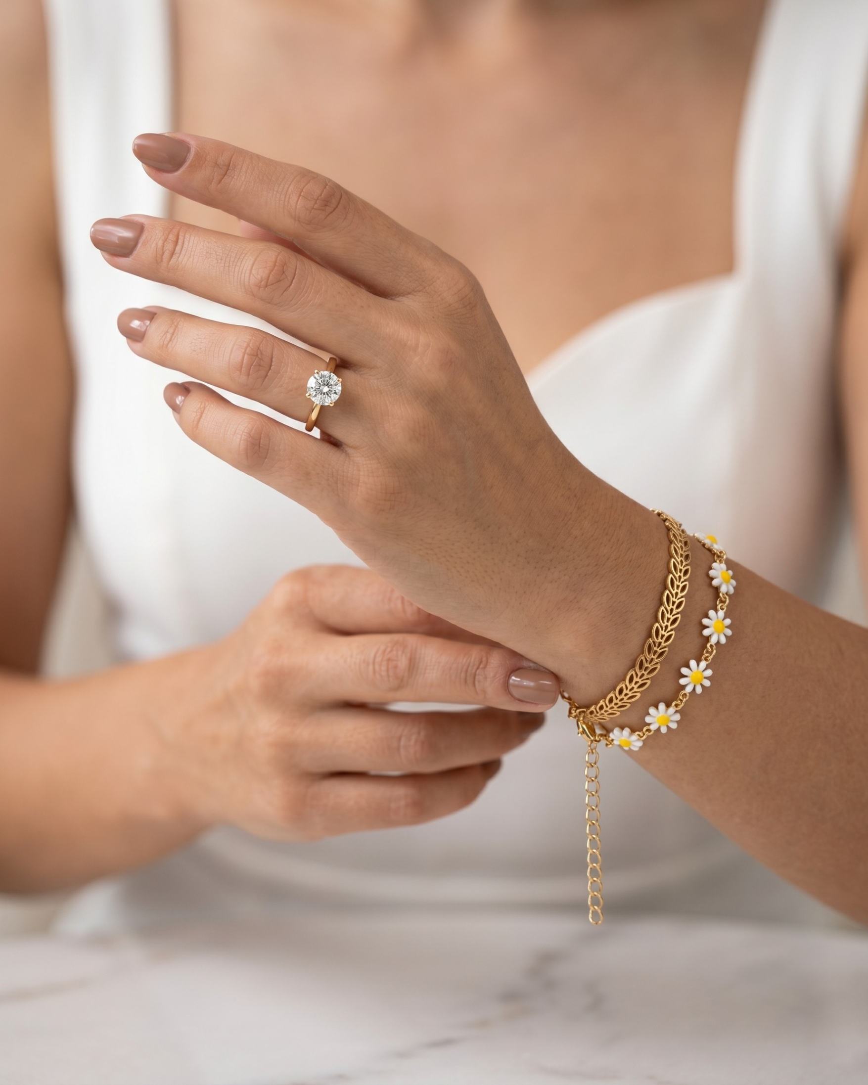 Gold plated daisy and leaf bracelet stack for women. 2 piece layered botanical link bracelets India. Lightweight office wear jewelry for working women. Enamel flower and chevron charm bracelet set alloy. Diwali and Rakhi jewelry gifts for wives. Gold tone festive wrist accessories for girls and friends.