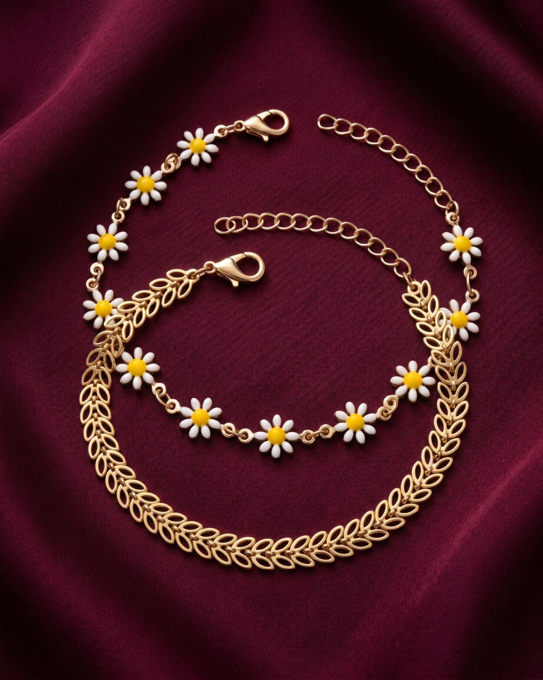 Gold plated daisy and leaf bracelet stack for women. 2 piece layered botanical link bracelets India. Lightweight office wear jewelry for working women. Enamel flower and chevron charm bracelet set alloy. Diwali and Rakhi jewelry gifts for wives. Gold tone festive wrist accessories for girls and friends.